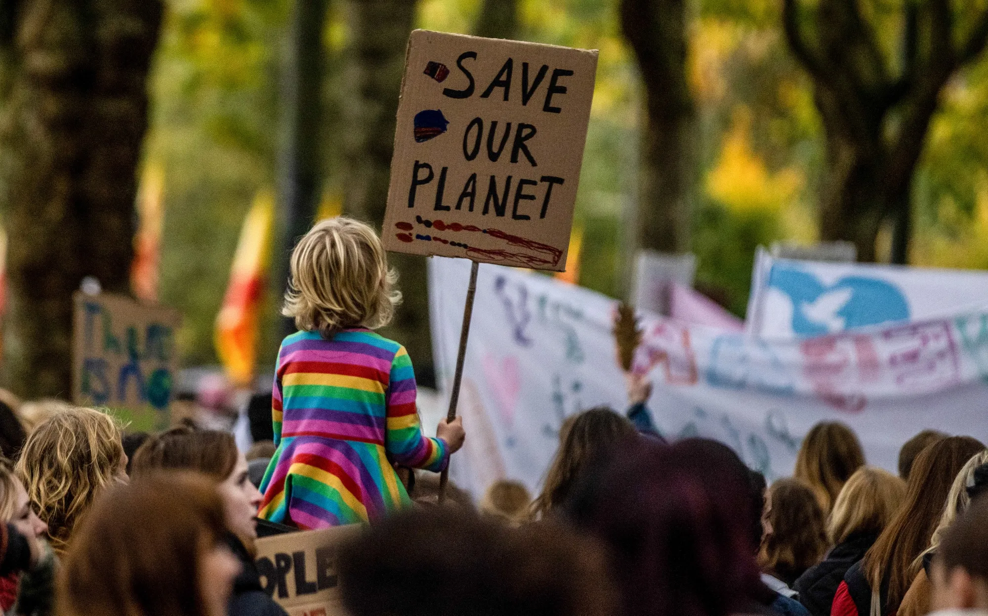 A young climate activist holding a placard reading "Save our planet" during a protest march on the "Youth Day" at the COP26 climate talks in Glasgow, UK, on&nbsp;Nov. 5, 2021.&nbsp;