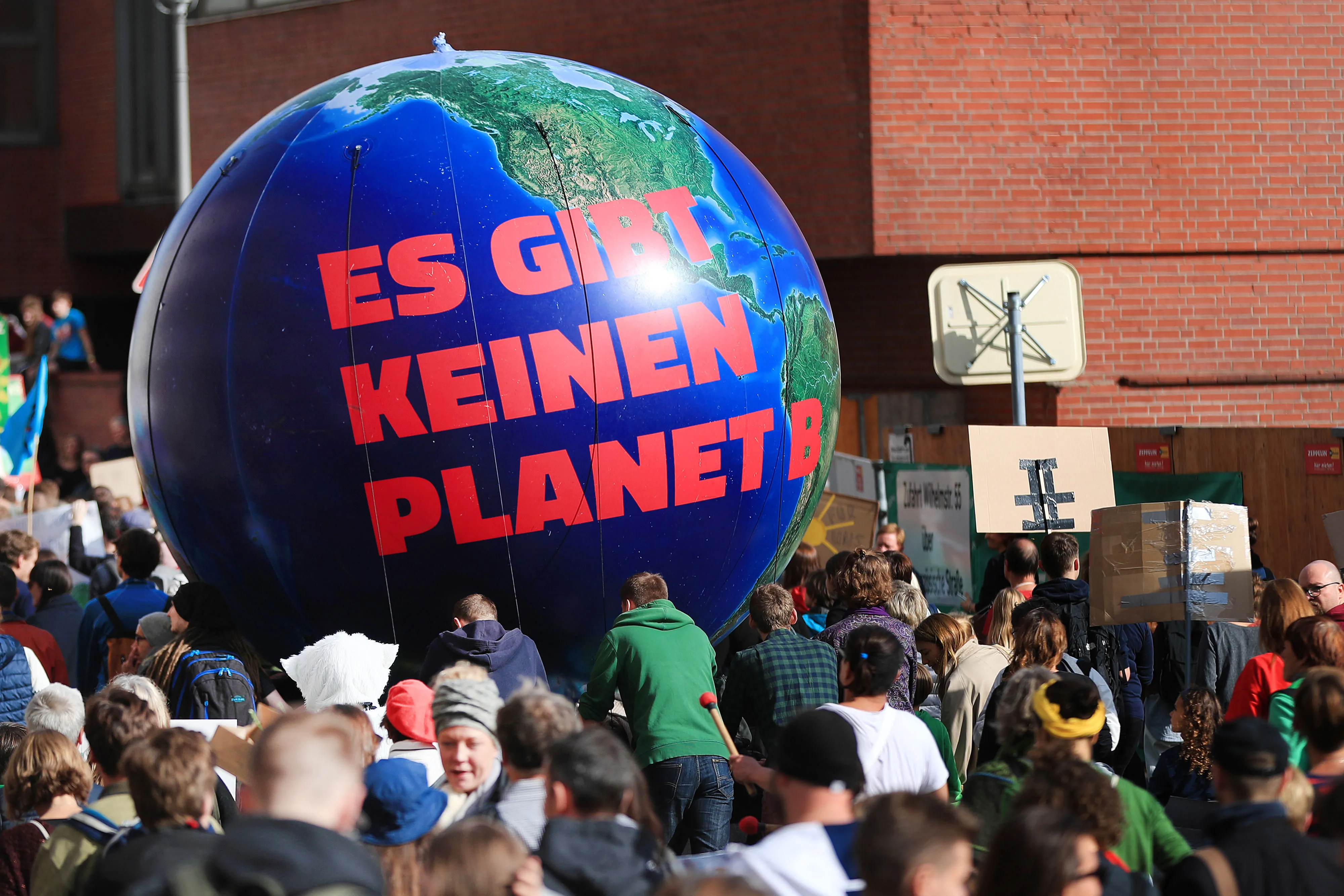 Protesters march near an inflatable globe during the Global Climate Strike demonstration in Berlin, Germany, on Friday, Sept. 20, 2019.