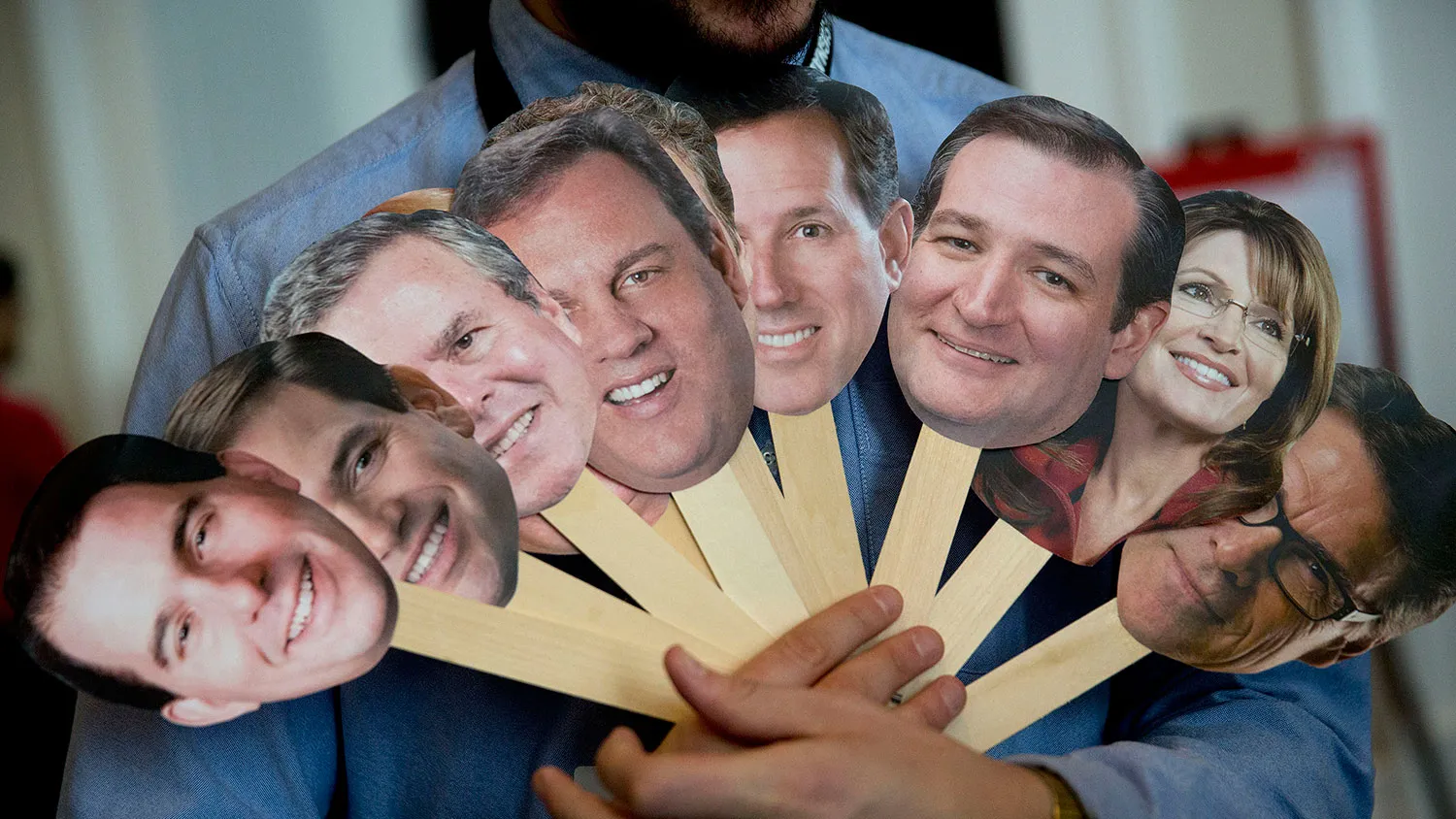 Attendee Adam Gabbatt holds photos of possible presidential candidates to question attendees during the Conservative Political Action Conference (CPAC) on Feb. 26, 2015.
