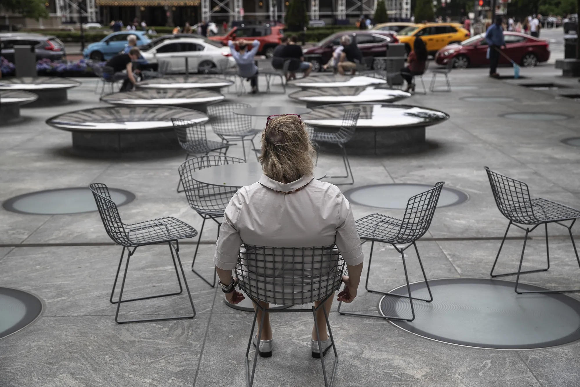 A person sits in a plaza on Fifth Avenue in New York City in 2021.&nbsp;