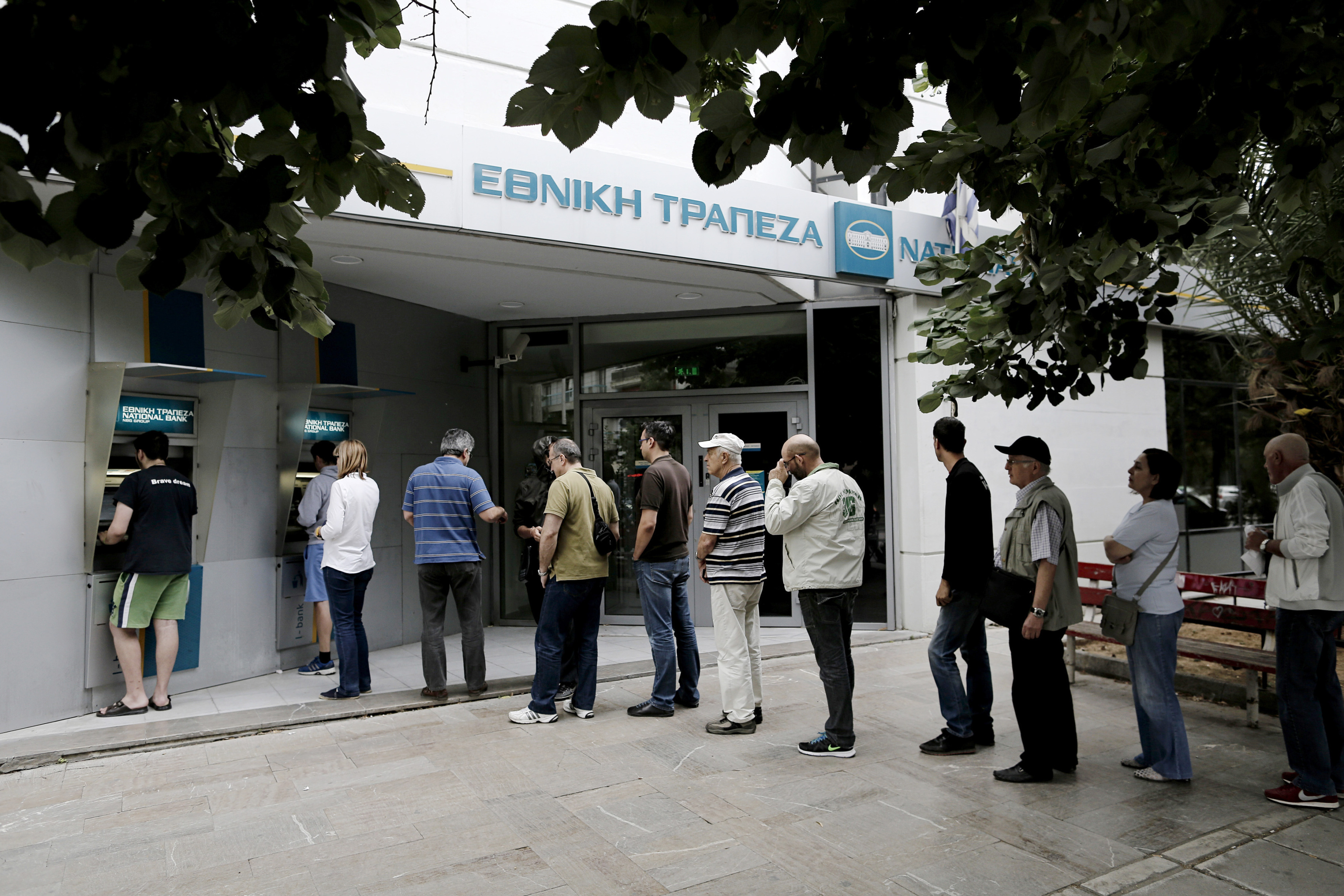 Greeks line up at banks this morning. Photographer: Konstantinos Tsakalidis/Bloomberg
