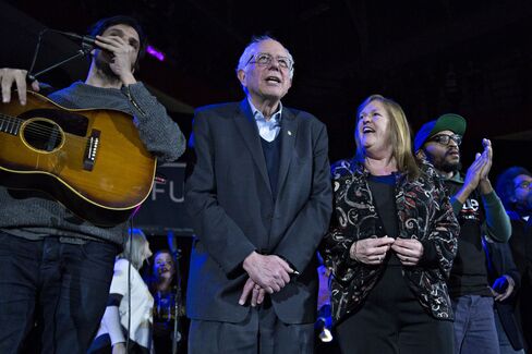 Bernie and Jane Sanders sing “This Land is Your Land” during a campaign rally at the University of Iowa Field House in Iowa City on Jan. 30, 2016.