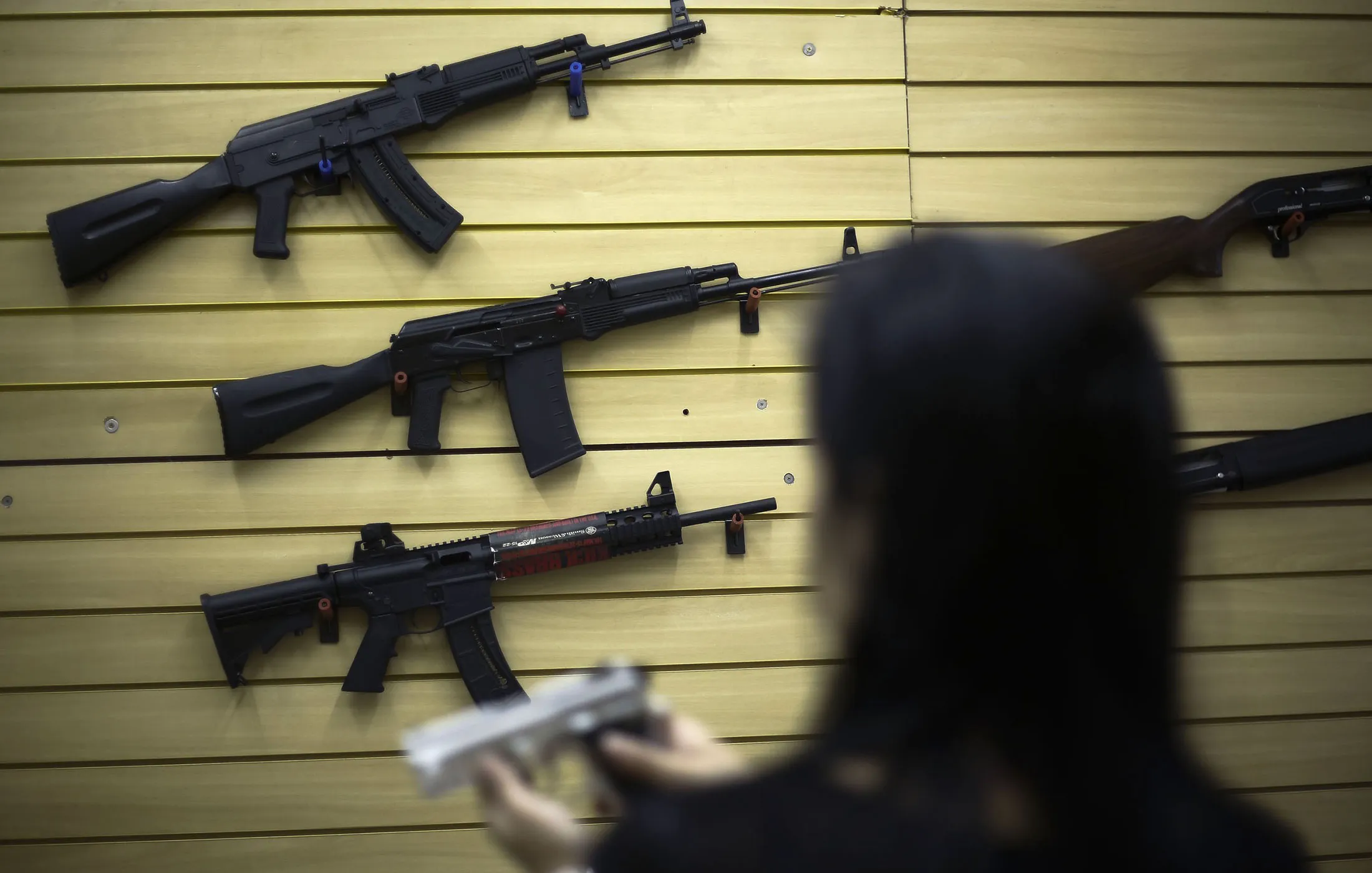 A woman handles a pistol at a gun store&nbsp;in Sao Paulo.&nbsp;