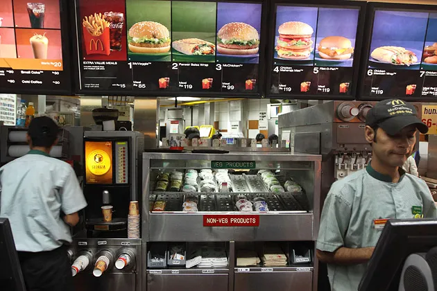 Employees work at a McDonald's restaurant in Noida, near New Delhi