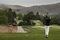 A woman tees off at the North Ranch Country Club in Thousand Oaks, Calif. A company called Integrity Golf is replacing more than 37 acres of turf with decomposed granite, mulch, and drought-resistant plants.