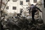 A Syrian man inspects the wreckage of a collapsed hospital after an airstrike in Damascus, on May 1, 2017.
