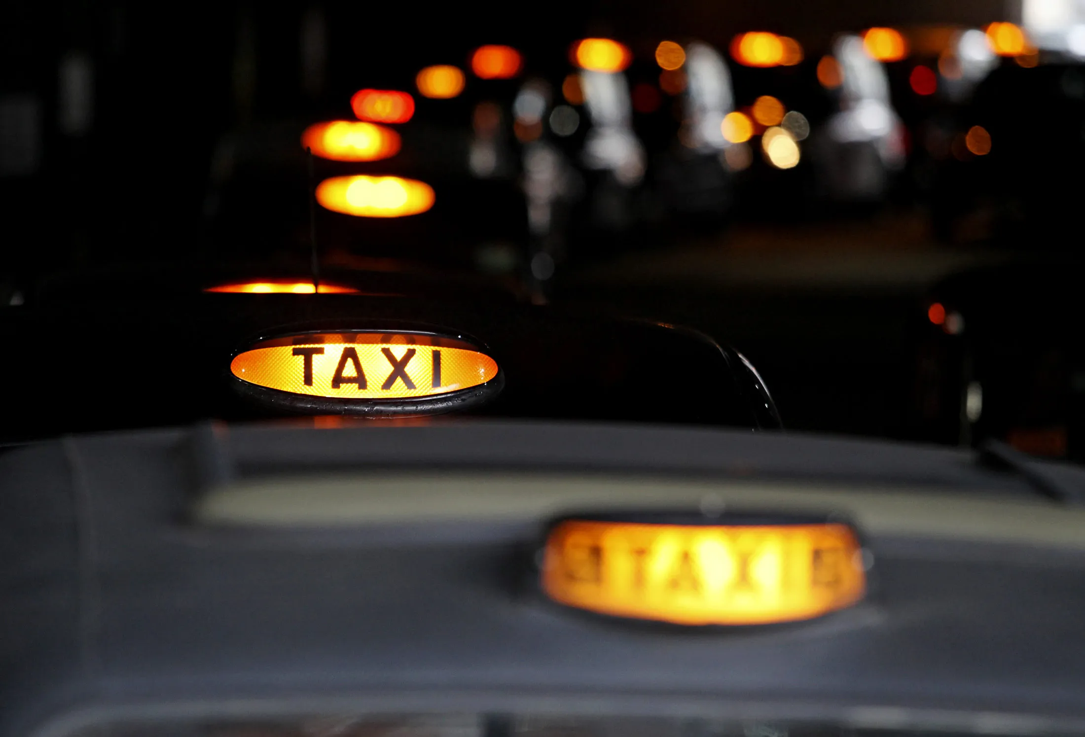 A queue of London taxis have their lights on showing they are available for a fare in London, U.K., on Friday, May 4, 2012. Olympic tourists seeking to hire one of London's 9,000 black taxis during the events may struggle as drivers quit the streets in protest against travel restrictions.
