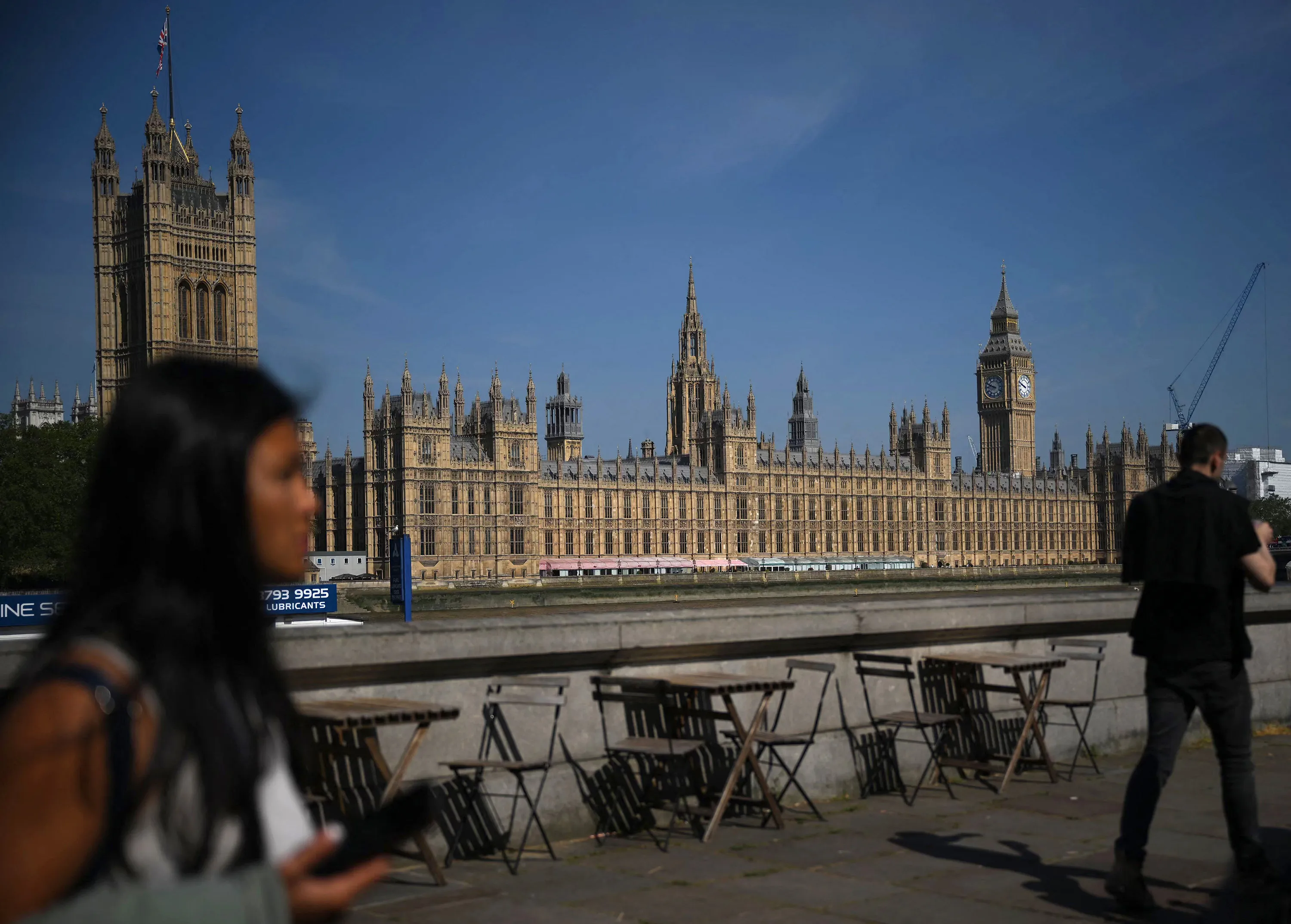 People walk past&nbsp;the Houses of Parliament&nbsp;in London.