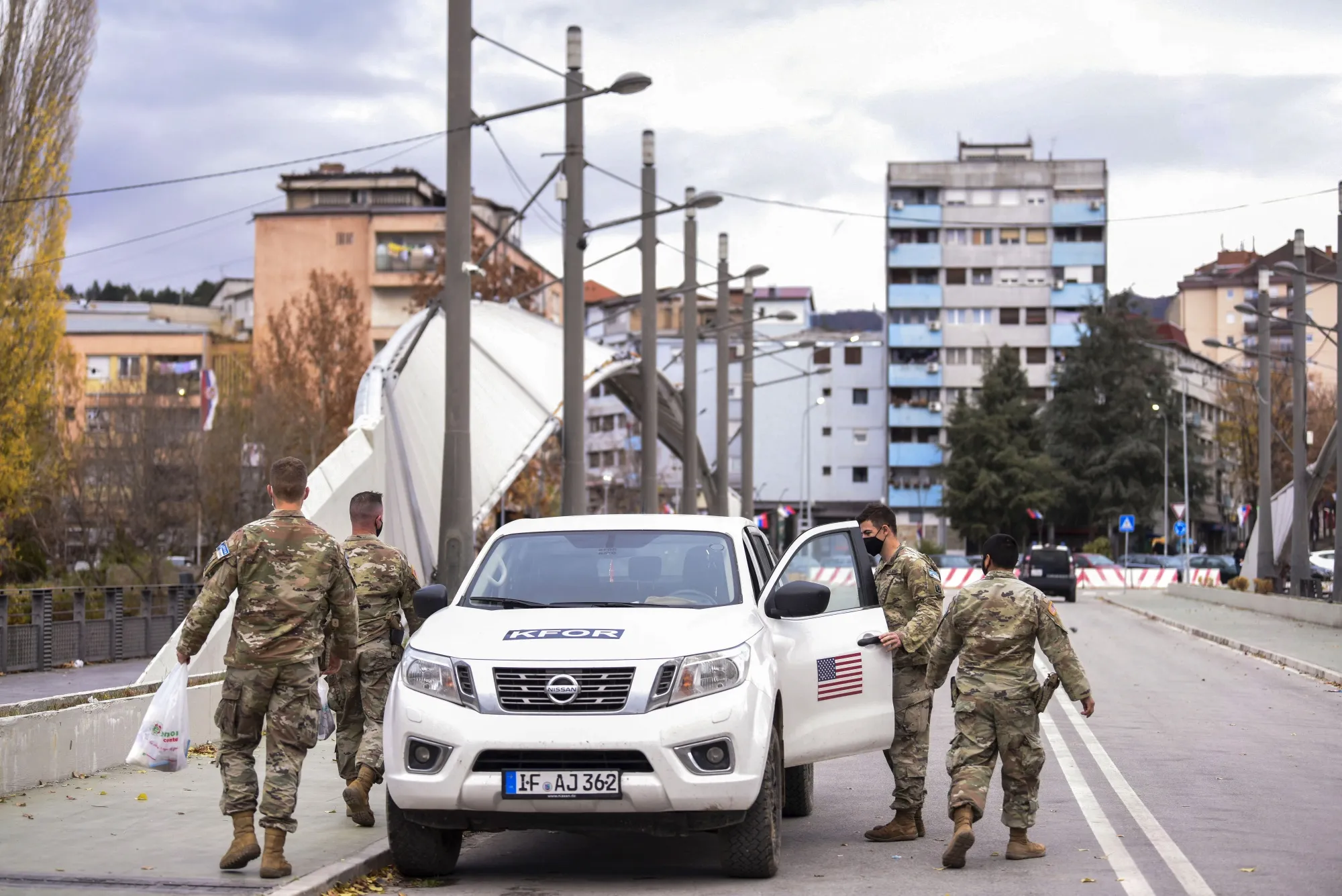 US NATO soldiers patrol over the Ibar river bridge in the town of Mitrovica, Kosovo.