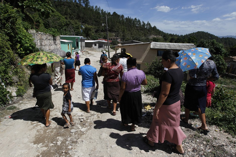 Women walk in the small village of El Guantillo, on outskirts of Tegucigalpa. 