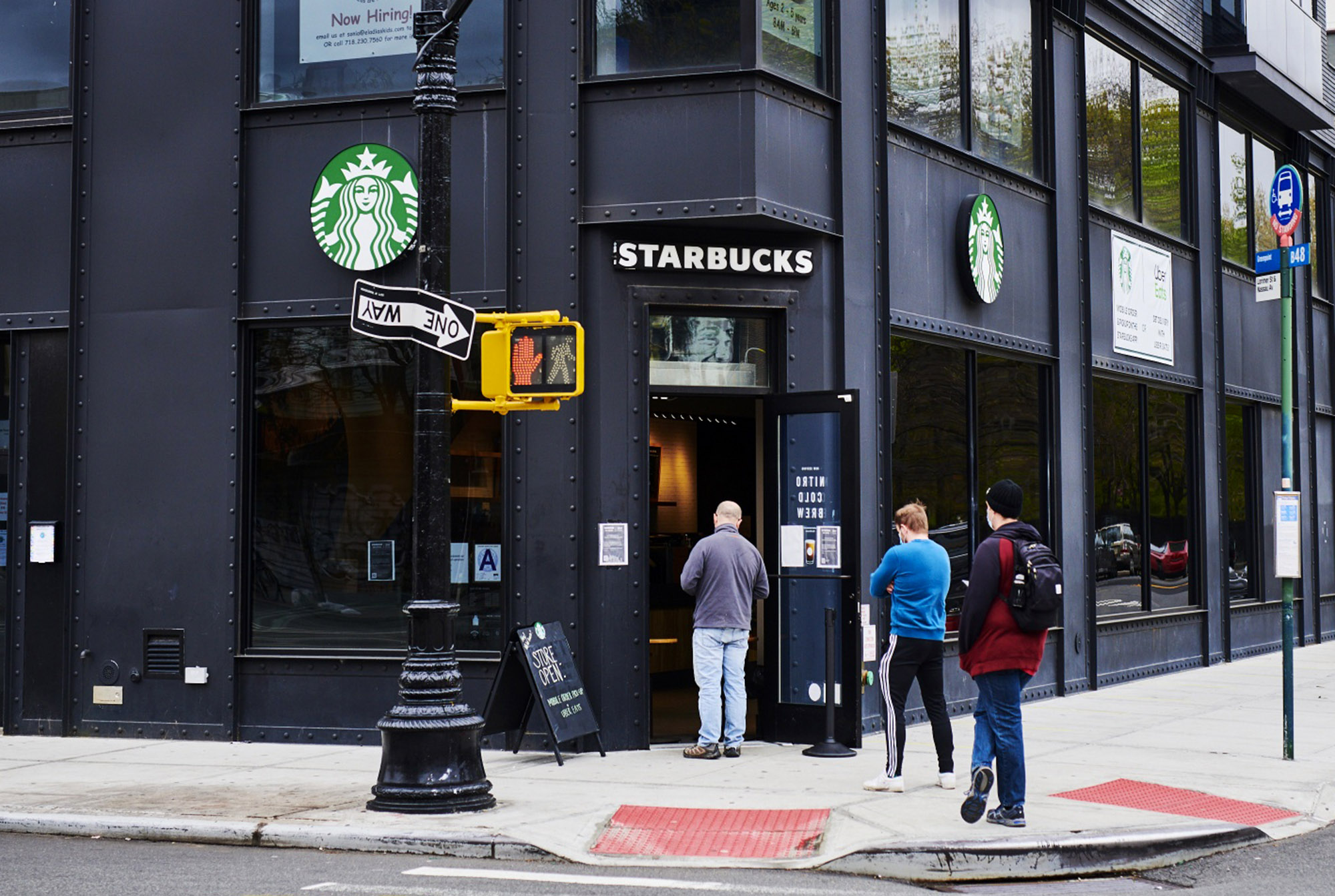 Customers wait in line at a Starbucks in Brooklyn, New York on April 27.