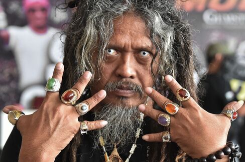 An Indonesian man displays his collection of rings with various gemstones in Jakarta on Aug. 6, 2015. The recent fad of collecting rings with precious gemstone or polished gemstone locally called "batu akik" is sweeping across Indonesia, with collectors going for the very rare stones and it's possession many believe will give the owner supernatural powers.