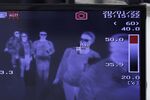 A monitor displays an image of a thermal scanner as passengers pass through a quarantine station at Narita Airport in Japan&nbsp;on&nbsp;Jan. 22.
