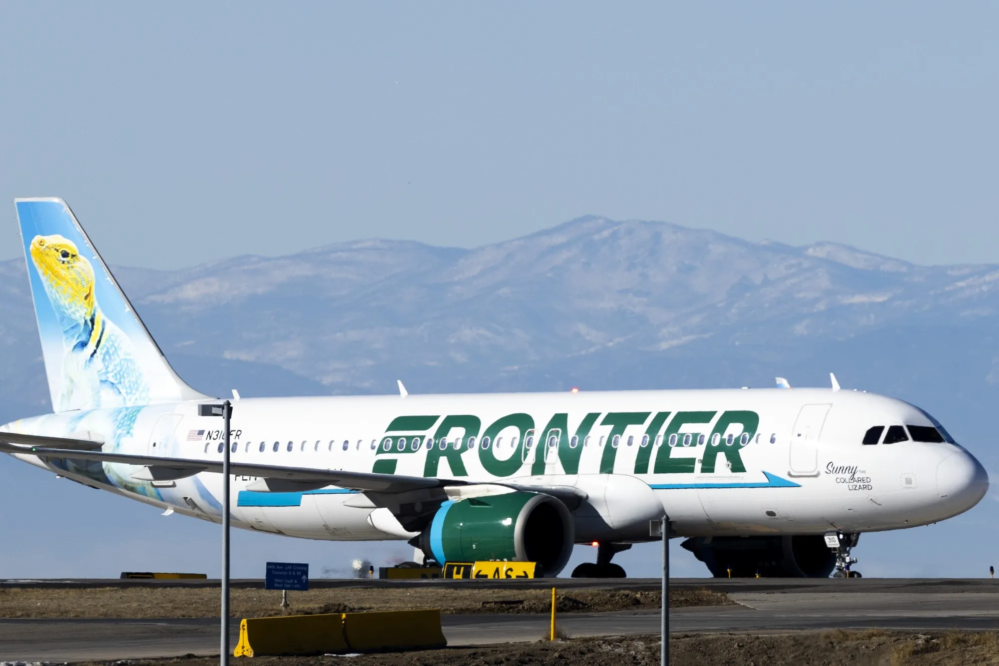 A Frontier Airlines airplane taxis to a gate at Denver International Airport in Denver, Colorado, in 2022.