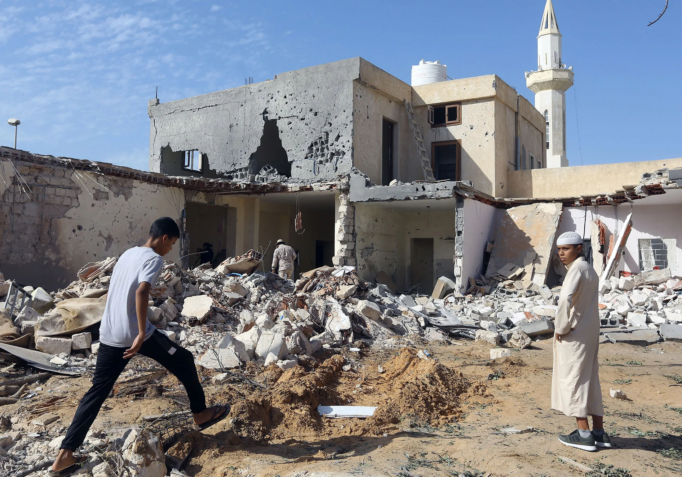 Libyans check the site of an air strike&nbsp;on the southern outskirts of the capital Tripoli on Oct.&nbsp;14.