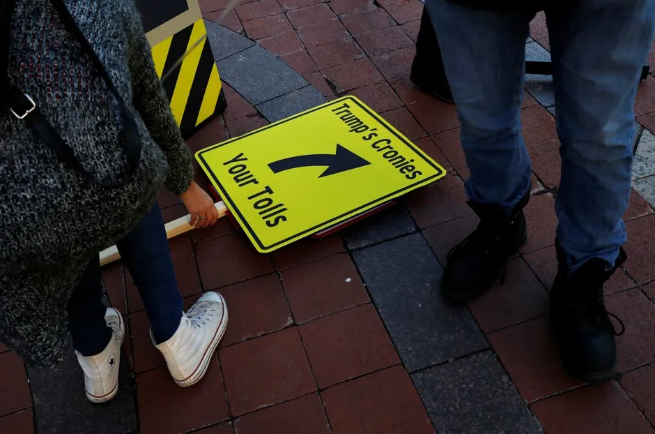 People get ready to protest U.S. President Donald Trump's recently unveiled infrastructure plan outside of the Trump International Hotel in Washington, D.C.