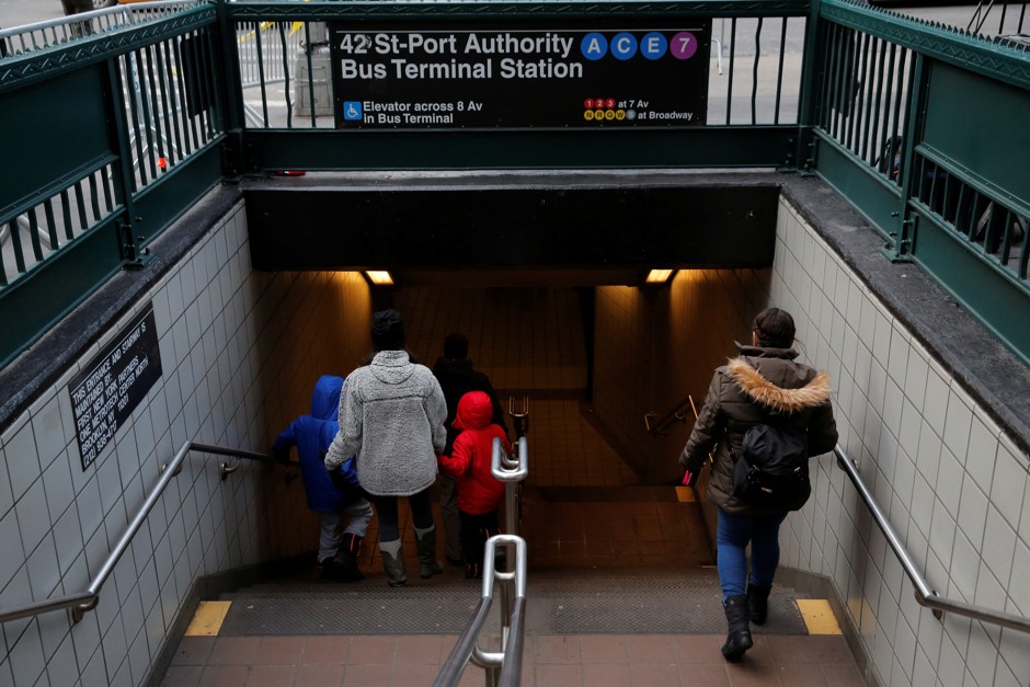 People enter the subway station by the New York Port Authority Bus Terminal station. 