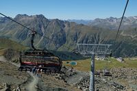 Summer tourists take the Flimjochbahn ski lift up to Flimjoch peak in Ischgl, Austria on Sept. 9. 