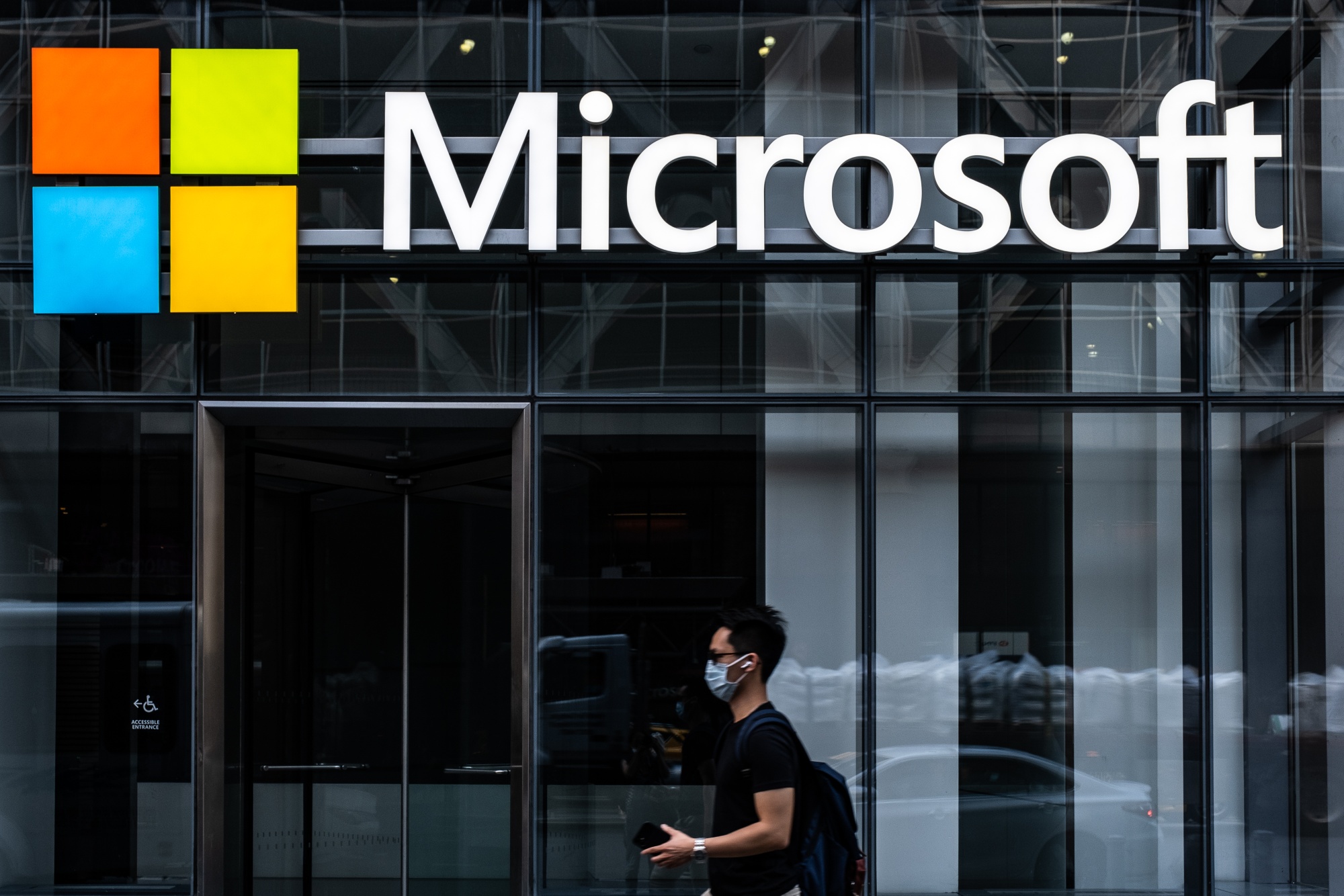 A pedestrian wearing a protective mask walks past a Microsoft Technology Centers in New York, U.S., on Wednesday, July 22, 2020.