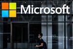 A pedestrian wearing a protective mask walks past a Microsoft Technology Centers in New York, U.S., on Wednesday, July 22, 2020.