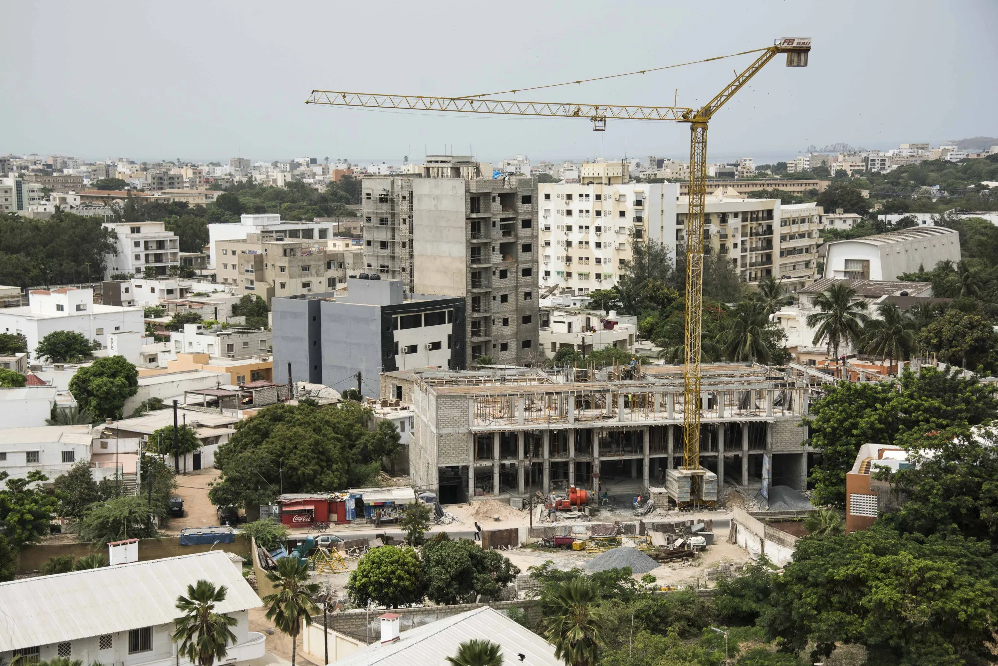 A crane stands above a building under construction in the Point E district in Dakar, Senegal, on Saturday, July 29, 2017.&nbsp;