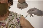 A healthcare worker administers a dose of the Sinovac Biotech Ltd. coronavirus vaccine during a vaccination event at the Cesfam Ignacio Domeyko health center in Santiago, Chile, on Wednesday, Feb. 3, 2021.