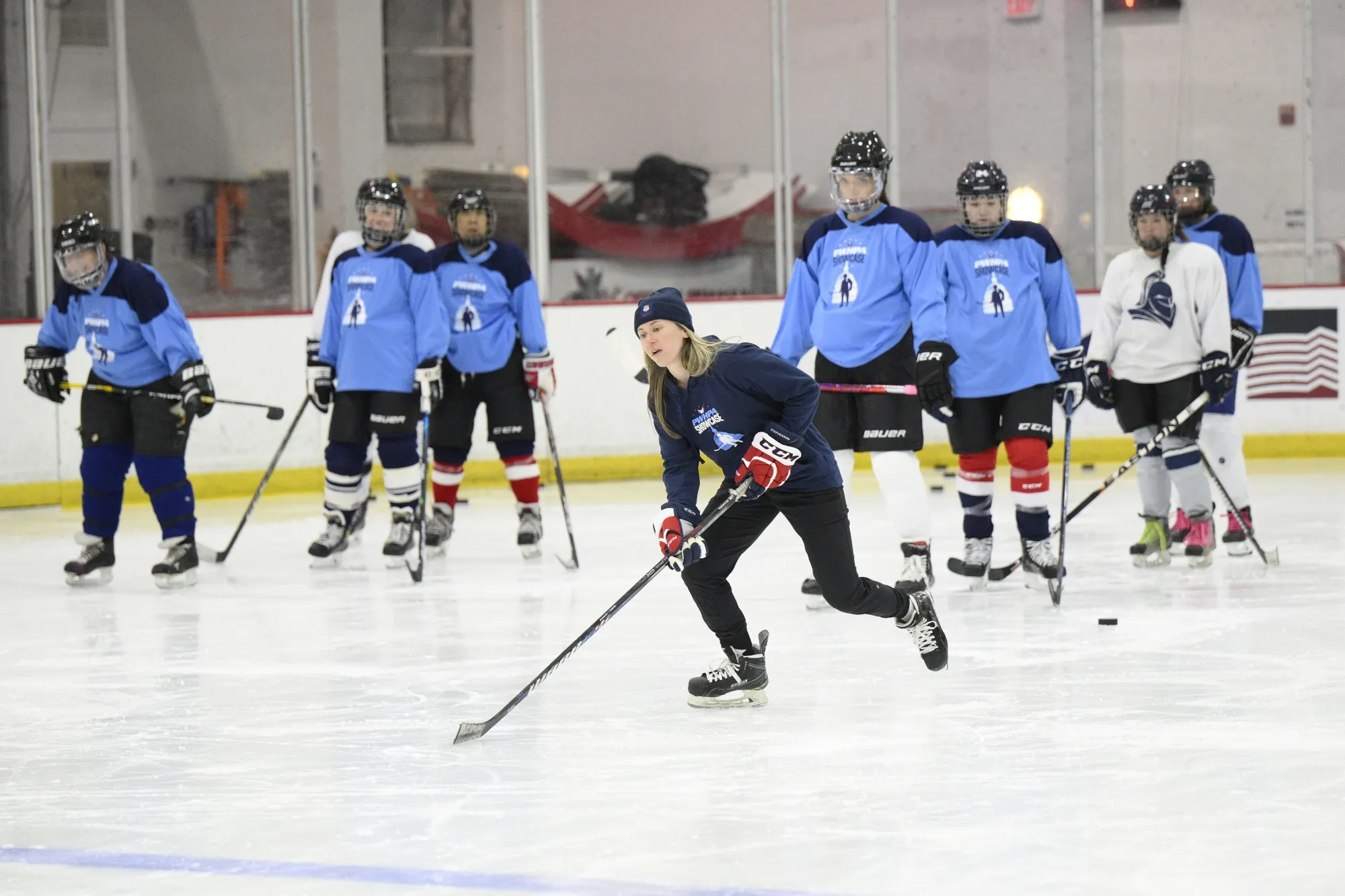 United States hockey player Haley Skarupa, front, demonstrates a drill during a hockey clinic presented by the Washington Capitals and the Professional Women's Hockey Players Association, Friday, March 4, 2022, in Arlington, Va. Montreal is finally getting its long-promised women’s pro hockey franchise, though the Premier Hockey Federation put the brakes on adding a second expansion team entering its eighth season, the league announced Tuesday, July 12, 2022. (AP Photo/Nick Wass, File)