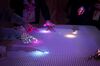 Attendees point to light patterns on a table being lit by the Interactive Tabletop Projector inside the Sony Corp. Wow Studio during the South By Southwest (SXSW) conference in Austin, Texas, U.S., on Monday, March 12, 2018. Amid the raucous parties and speed networking at the annual festival that draws people from technology, film, and music to Austin, Texas, there will be some soul searching about gender discrimination, sexual harassment and how to fix the broken workplace culture.
