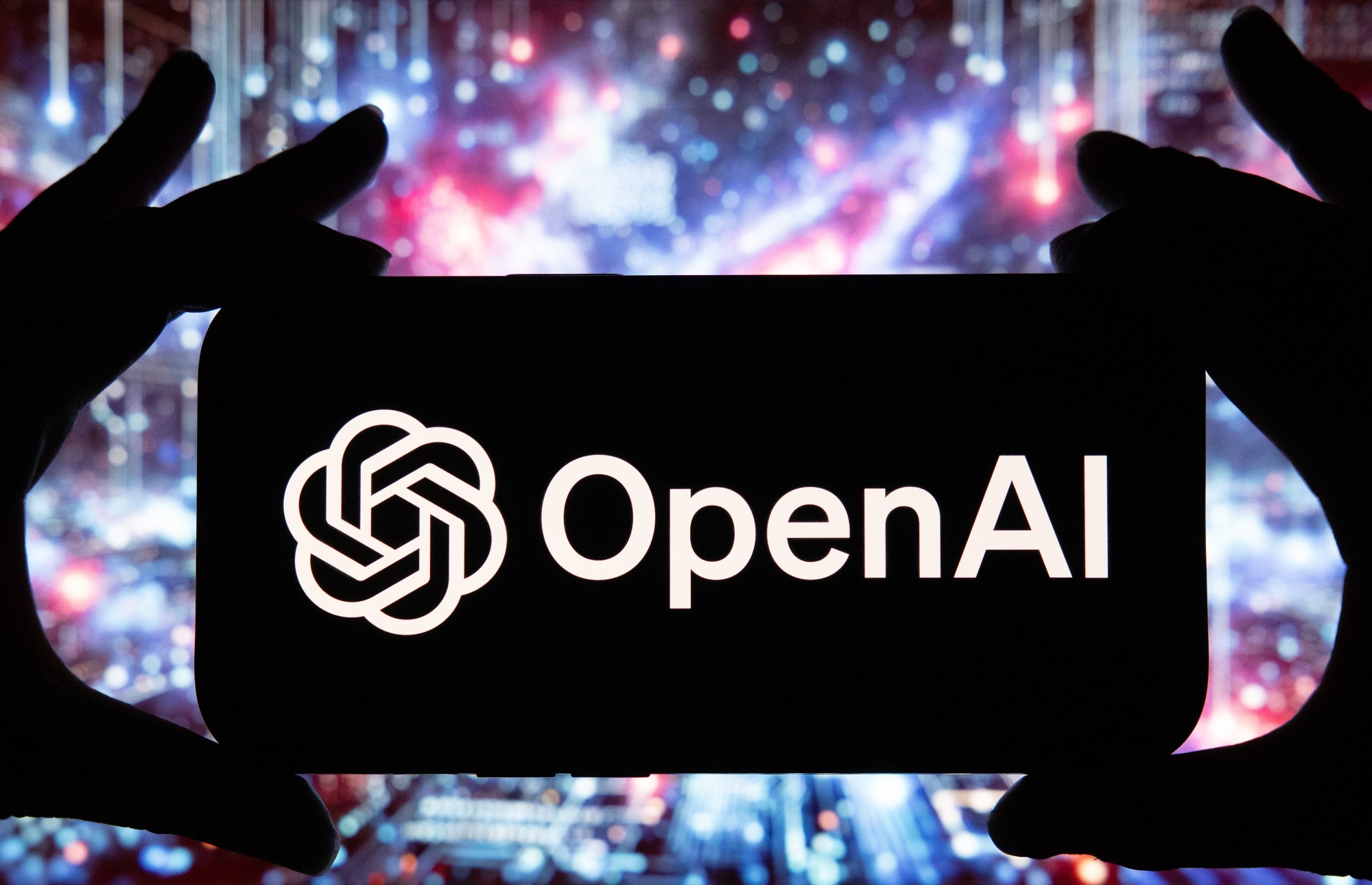 A symbol for the OpenAI virtual assistant on a smartphone, arranged in Riga, Latvia, on Friday, Aug. 16, 2024. The public release of advanced generative AI tools such as Google’s Gemini, Meta AI, and OpenAI’s ChatGPT over the past two years has heightened fears that millions of workers could be displaced. Photographer: Andrey Rudakov/Bloomberg