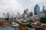 Commercial building beyond houses in Kuala Lumpur, Malaysia, on Friday, March 22. 2024. Malaysia is expected to release CPI figures on March 25.