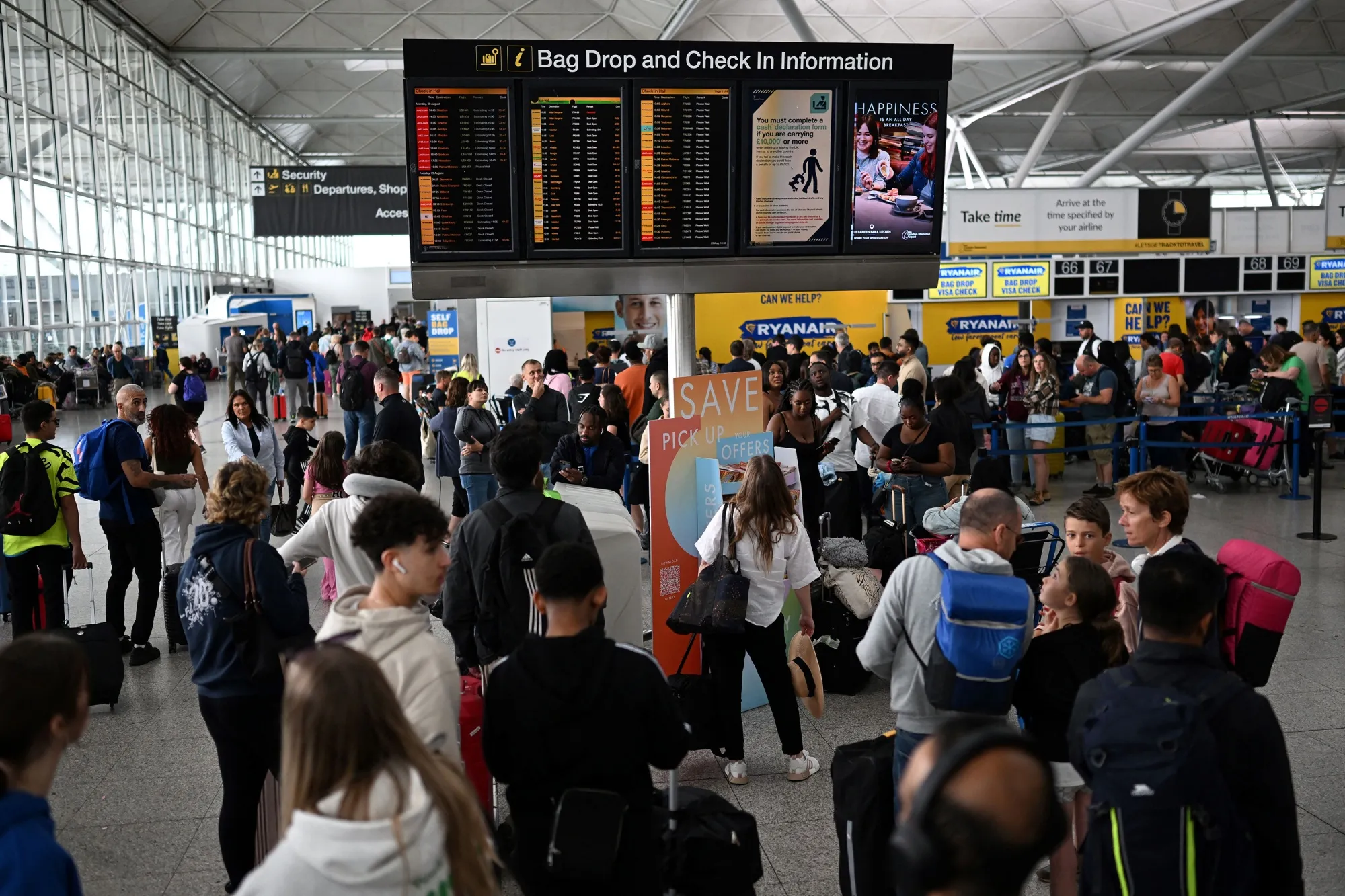 Passengers wait during flight delays at Stansted Airport, UK, on Aug.&nbsp;29.