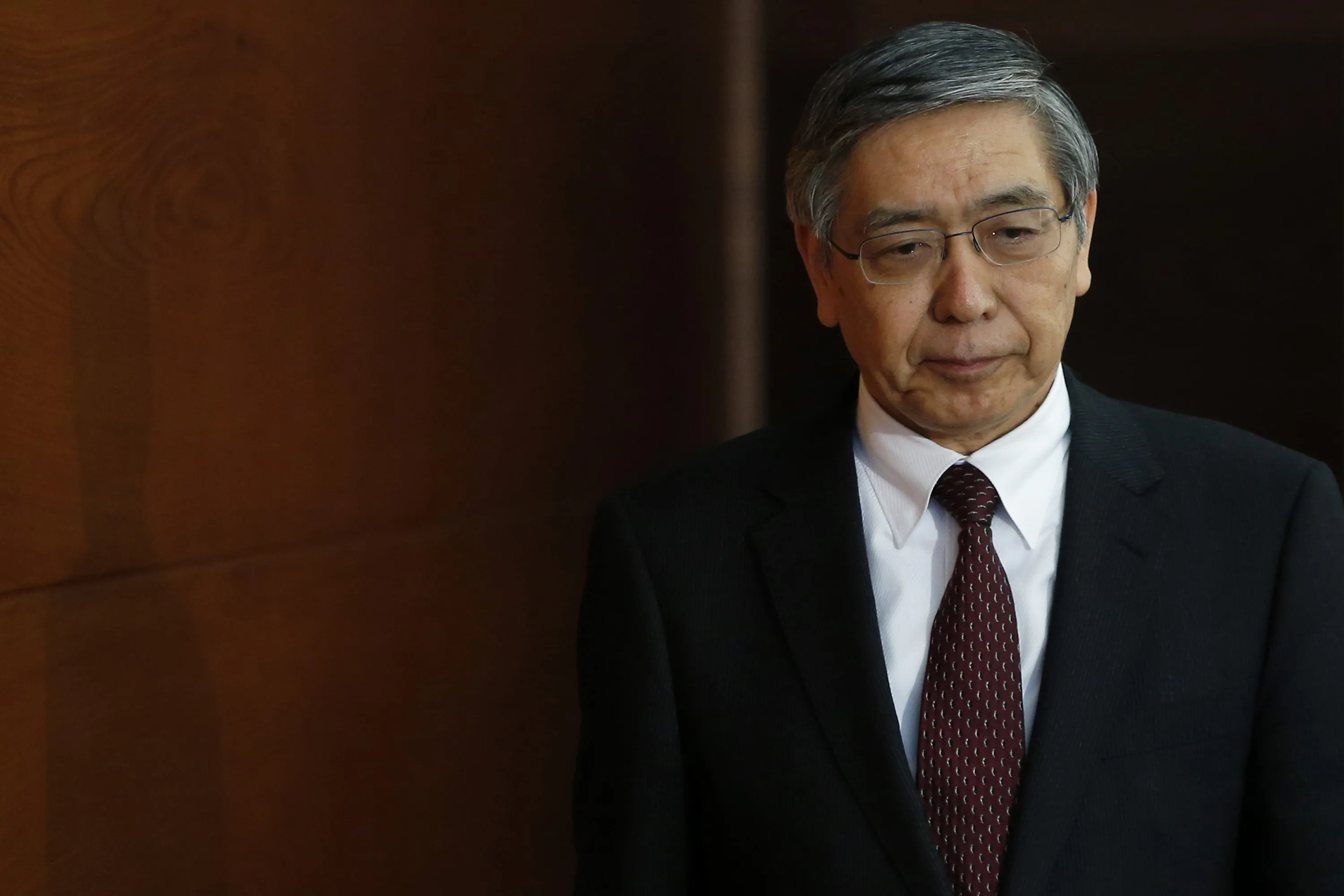Haruhiko Kuroda, governor of the Bank of Japan (BOJ), arrives for a news conference at the central bank's headquarters in Tokyo on Feb. 18, 2014. Photographer: Kiyoshi Ota/Bloomberg