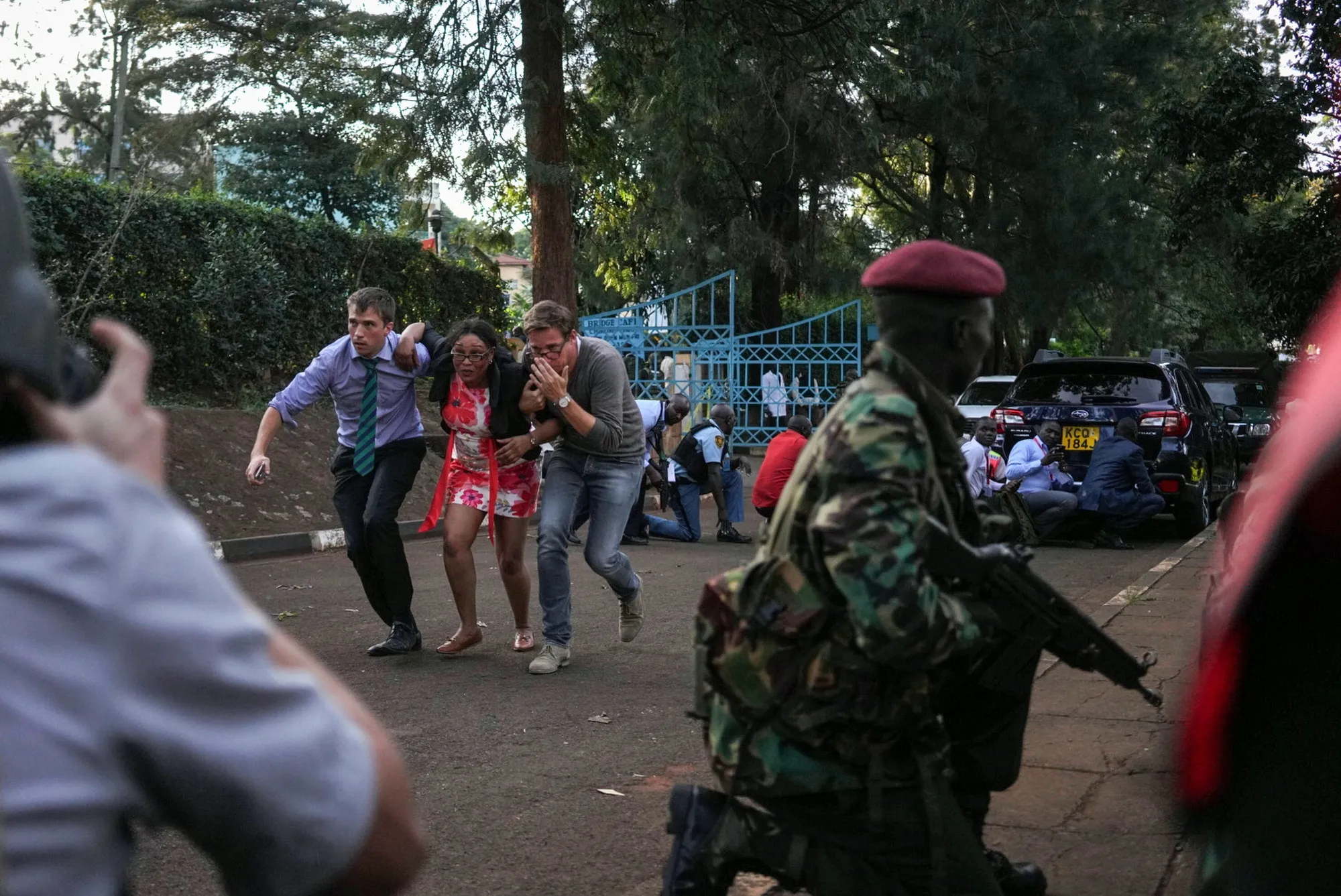 Pedestrians flee at the 14 Riverside Drive hotel and office complex in Nairobi on Jan. 15.