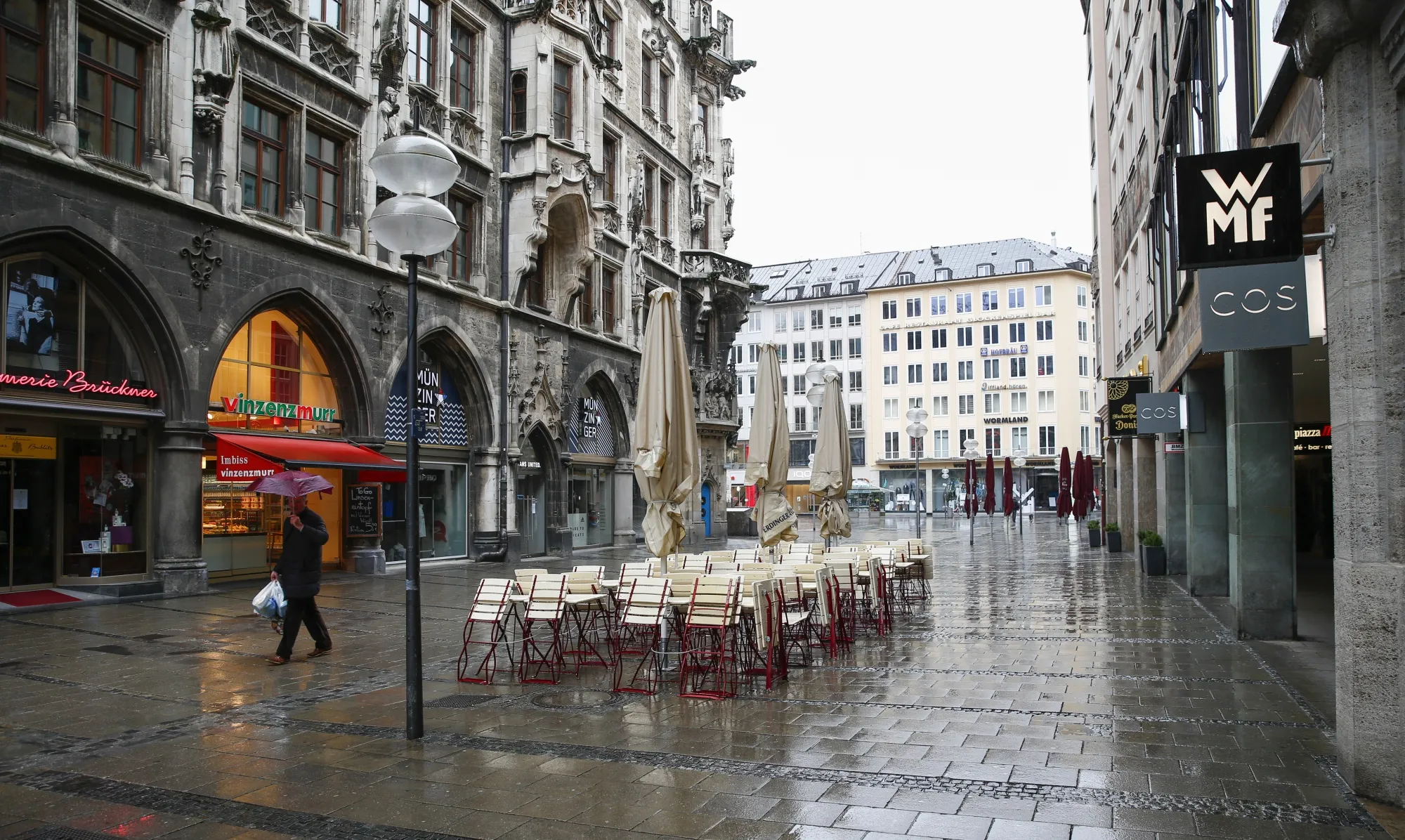 Stacked chairs and collapsed parasols from closed cafes stand in a near empty pedestrianized area of Munich, on March 21.