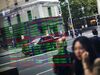 Pedestrians are reflected in a window as they walk past an electronic stock board at the ASX Ltd. exchange centre in Sydney, Australia, on Thursday, Feb. 14, 2019. We made good progress on our core initiatives across the period, including the program to replace CHESS with distributed ledger technology; upgrade of our secondary data centre to strengthen market resilience; and restructure of our Listings Compliance team to enhance the quality of market oversight, ASX Chief Executive Officer Dominic Stevens said.