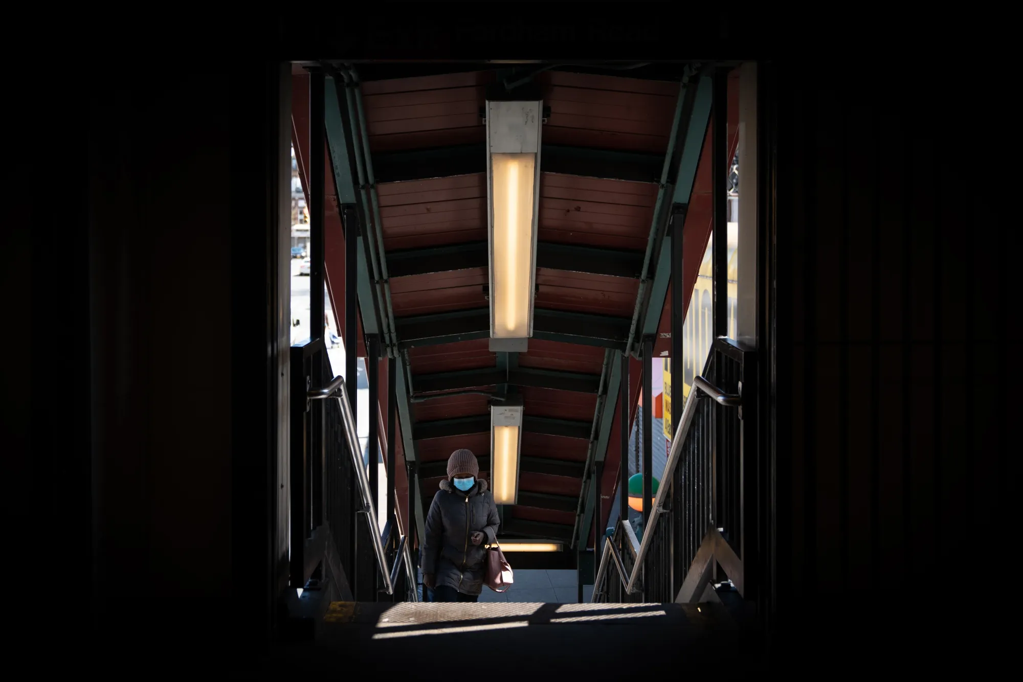 A commuter wearing a protective mask walks up the stairs to the subway in the Bronx borough of New York, on&nbsp;April 2.&nbsp;