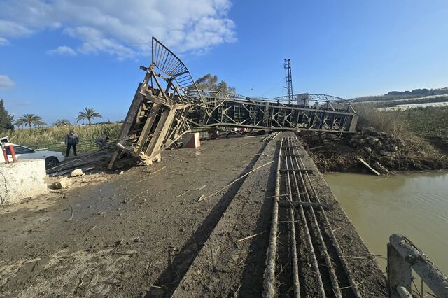 Civil defense members inspect the site of an Israeli airstrike on Qasmiyeh Bridge on April 8, 2026.