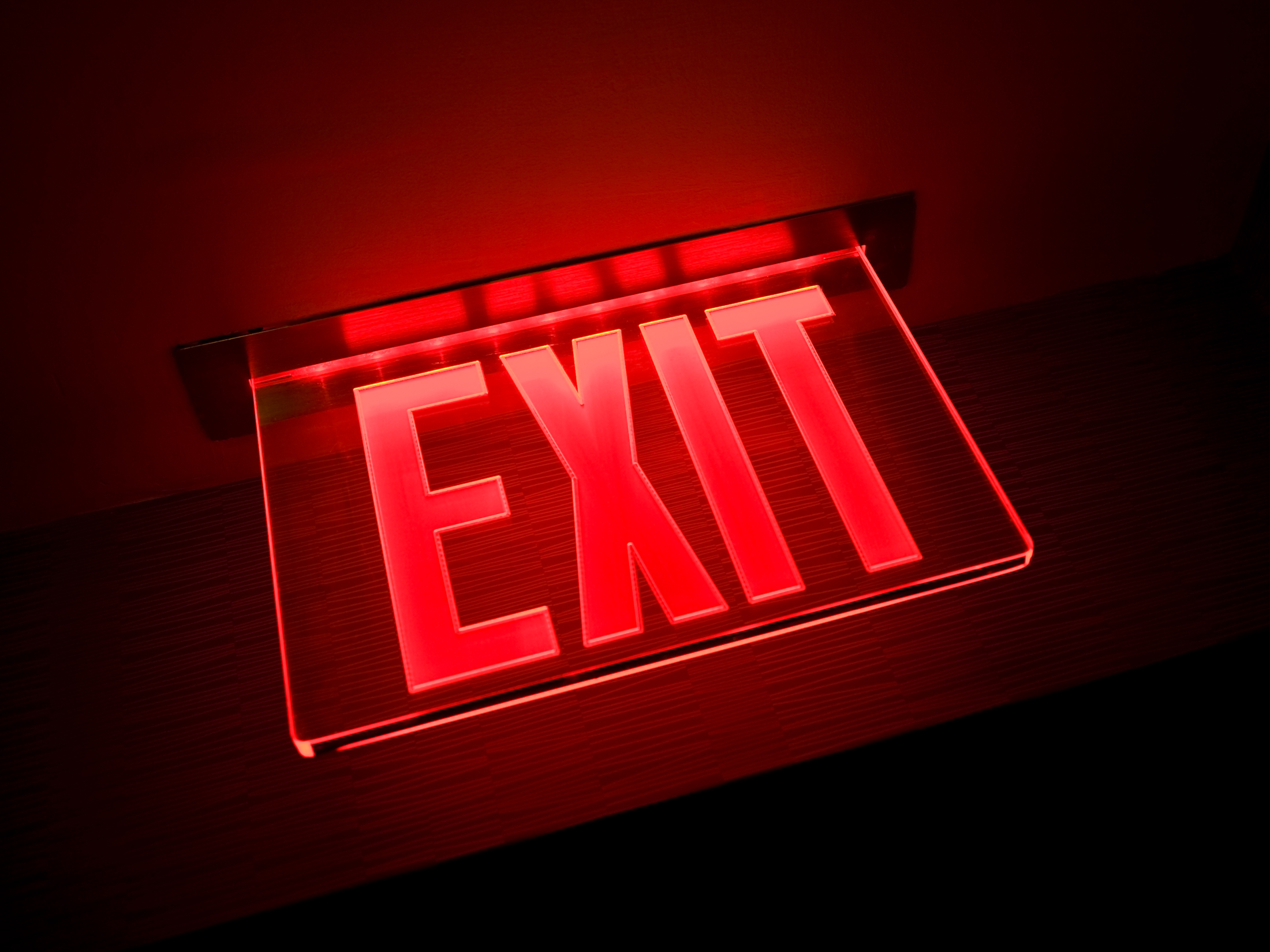 Exit sign illuminated, close-up, low angle view