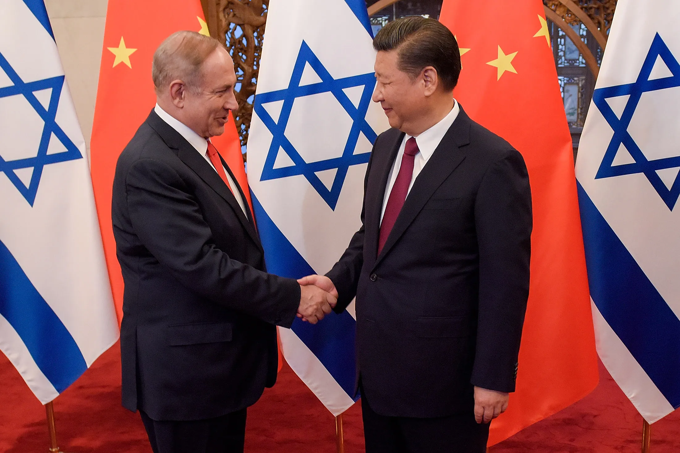 Xi Jinping, right, and Benjamin Netanyahu shake hands ahead of their talks at Diaoyutai State Guesthouse in Beijing, China, on March 21, 2017.
