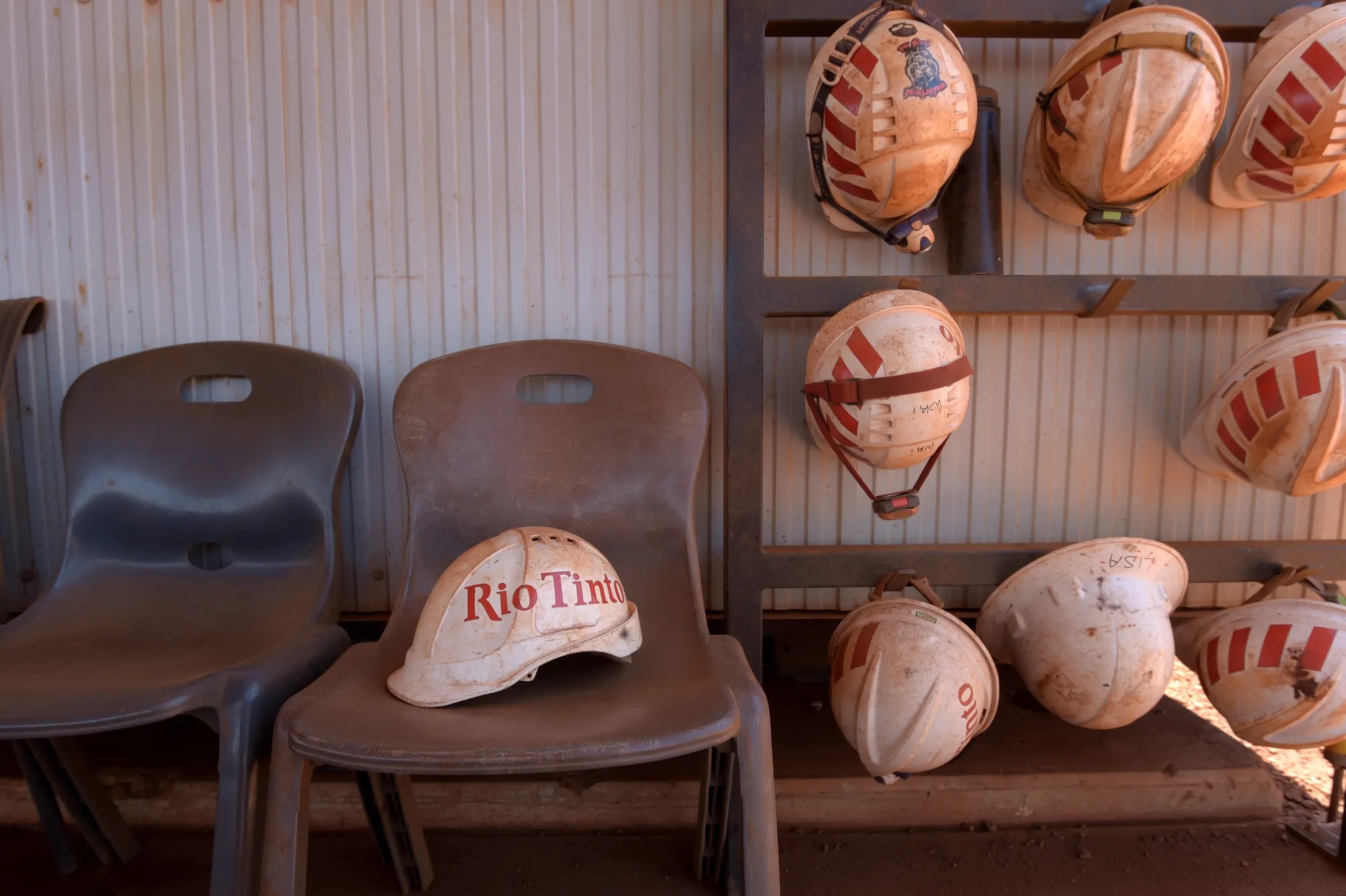 Safety hats outside a break room at the Rio Tinto Group's Gudai-Darri iron ore mine in the Pilbara region of Western Australia.
