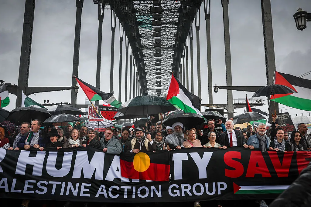 People march across Sydney Harbour Bridge, on Aug. 3.