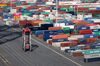 A straddle carrier vehicle transports cargo as shipping containers stand on the dockside at the Port of Le Havre in Le Havre, France, on Thursday, Sept. 6, 2018. France is benefiting from solid economic expansion in the euro zone after years of European Central Bank stimulus, and a trade dispute with the U.S. that could have led to higher tariffs seems to have subsided for now.