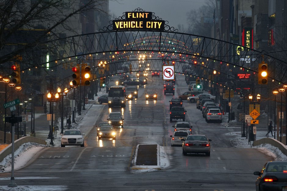 Vehicles drive through downtown Flint, Michigan, the original home of General Motors, on Jan. 21, 2016. 