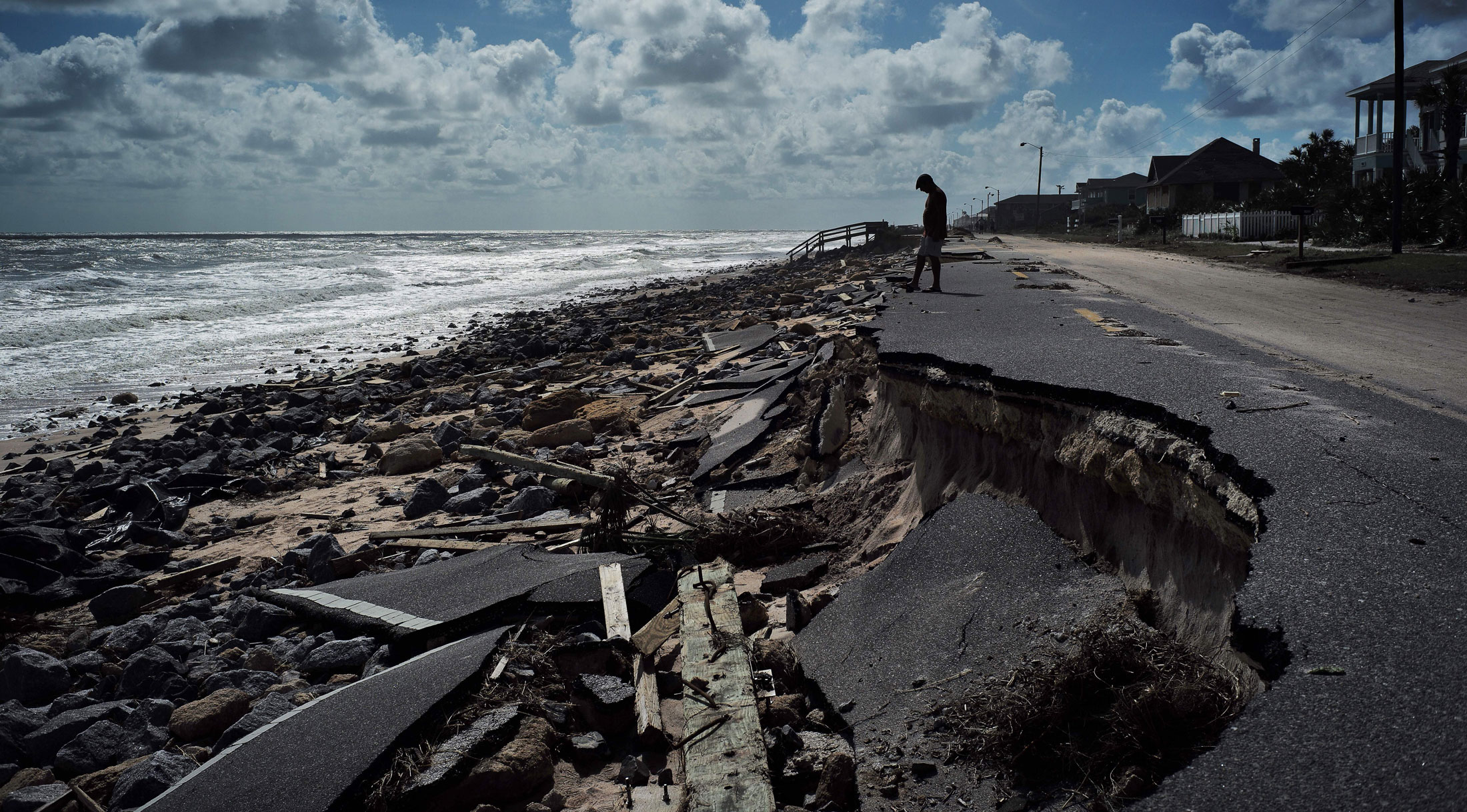 A resident looks at debris washed out by Hurricane Matthew in Flagler Beach, Fla., on Oct. 9.
