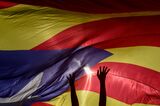 Demonstrators stand under a large pro-independence Catalan Estelada flag in Barcelona in 2019. 