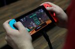 An attendee plays on a Nintendo Co. Switch video game console during the E3 Electronic Entertainment Expo in Los Angeles, California, U.S.