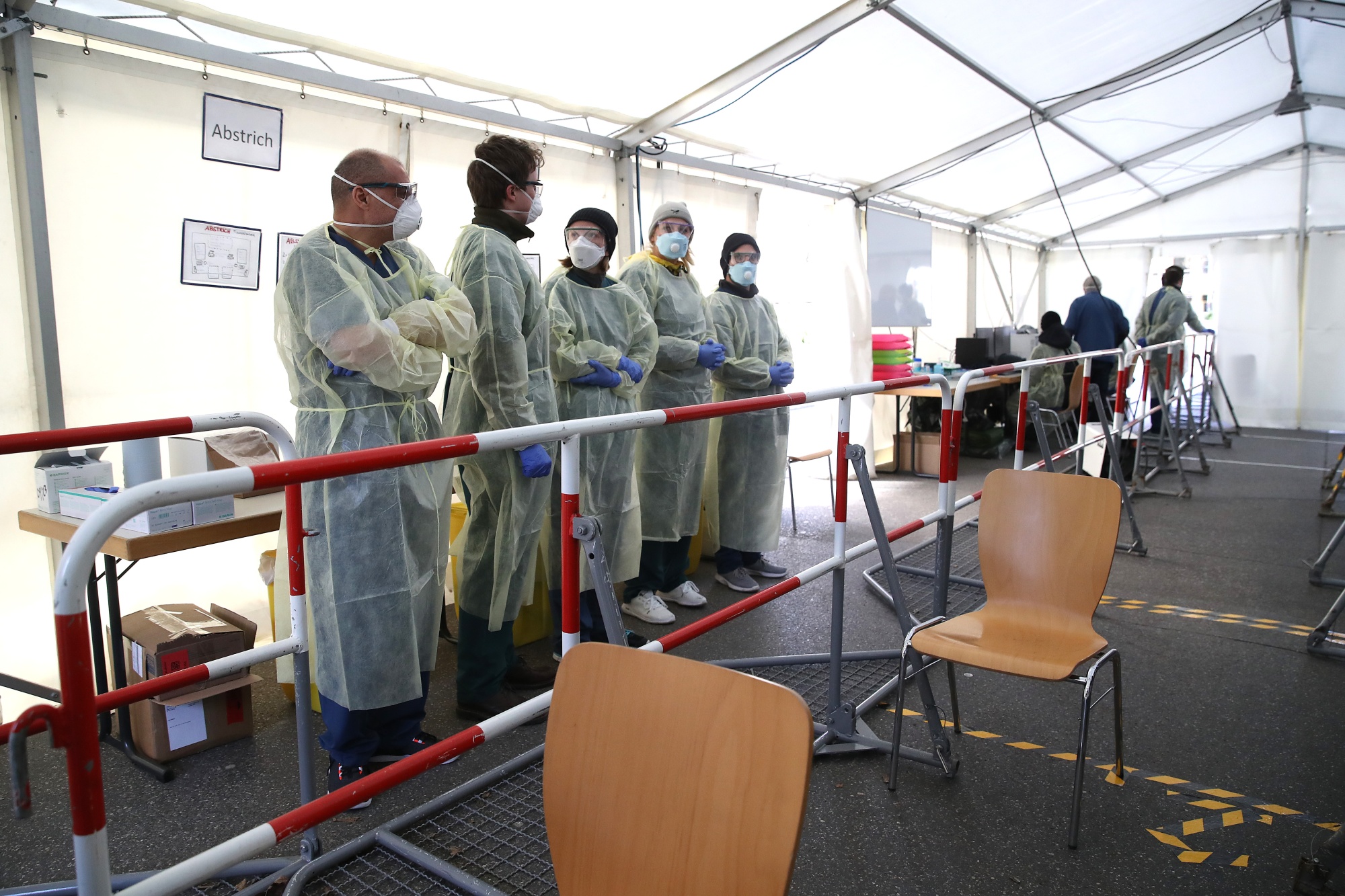 Medical personnel wait to take nose and throat mucous samples for coronavirus testing at a new outdoor facility in Munich, on March 23.&nbsp;