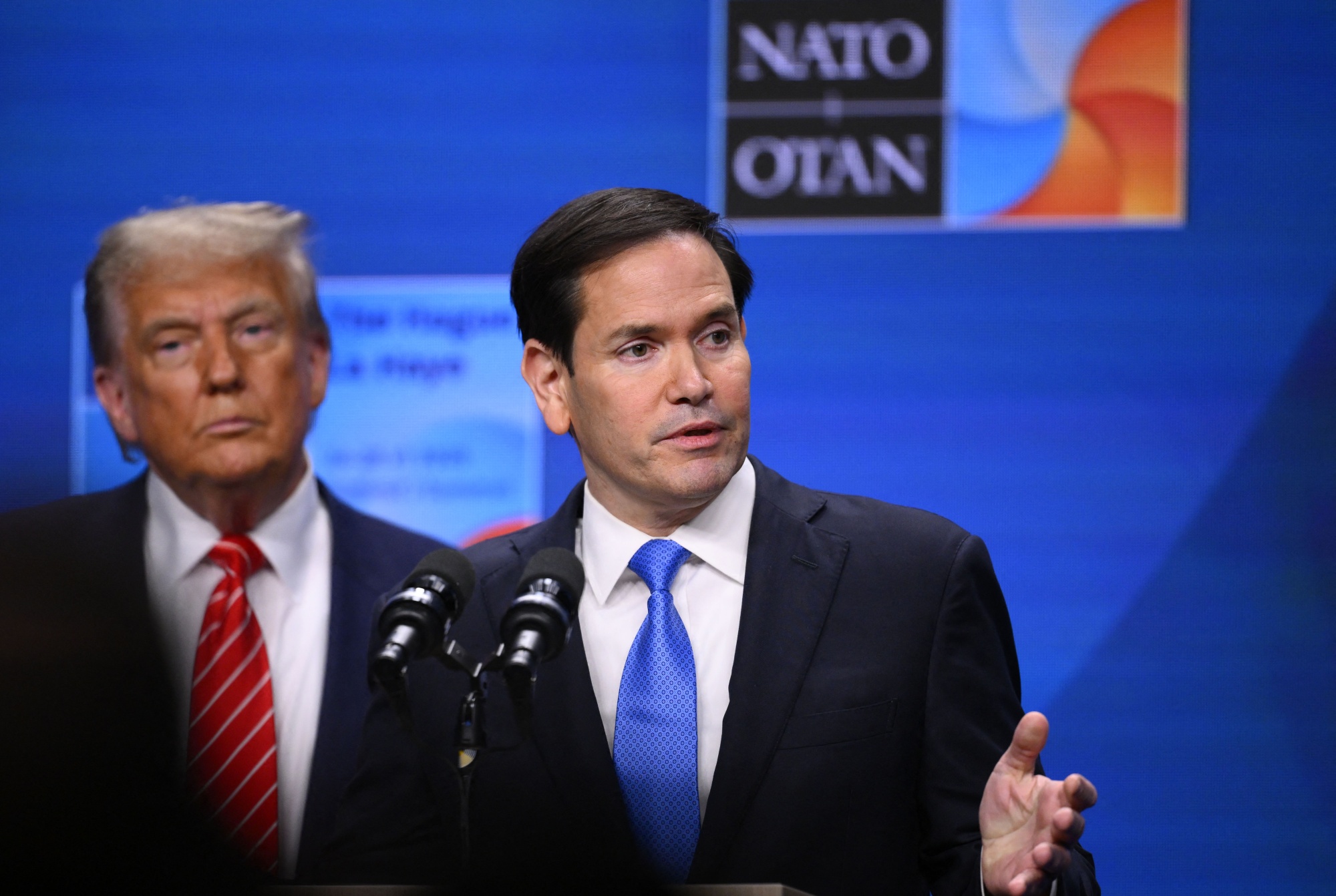 US Secretary of State Marco Rubio, right, flanked by US President Donald Trump, speaks at a press conference during the North Atlantic Treaty Organization (NATO) summit in The Hague on June 25, 2025.