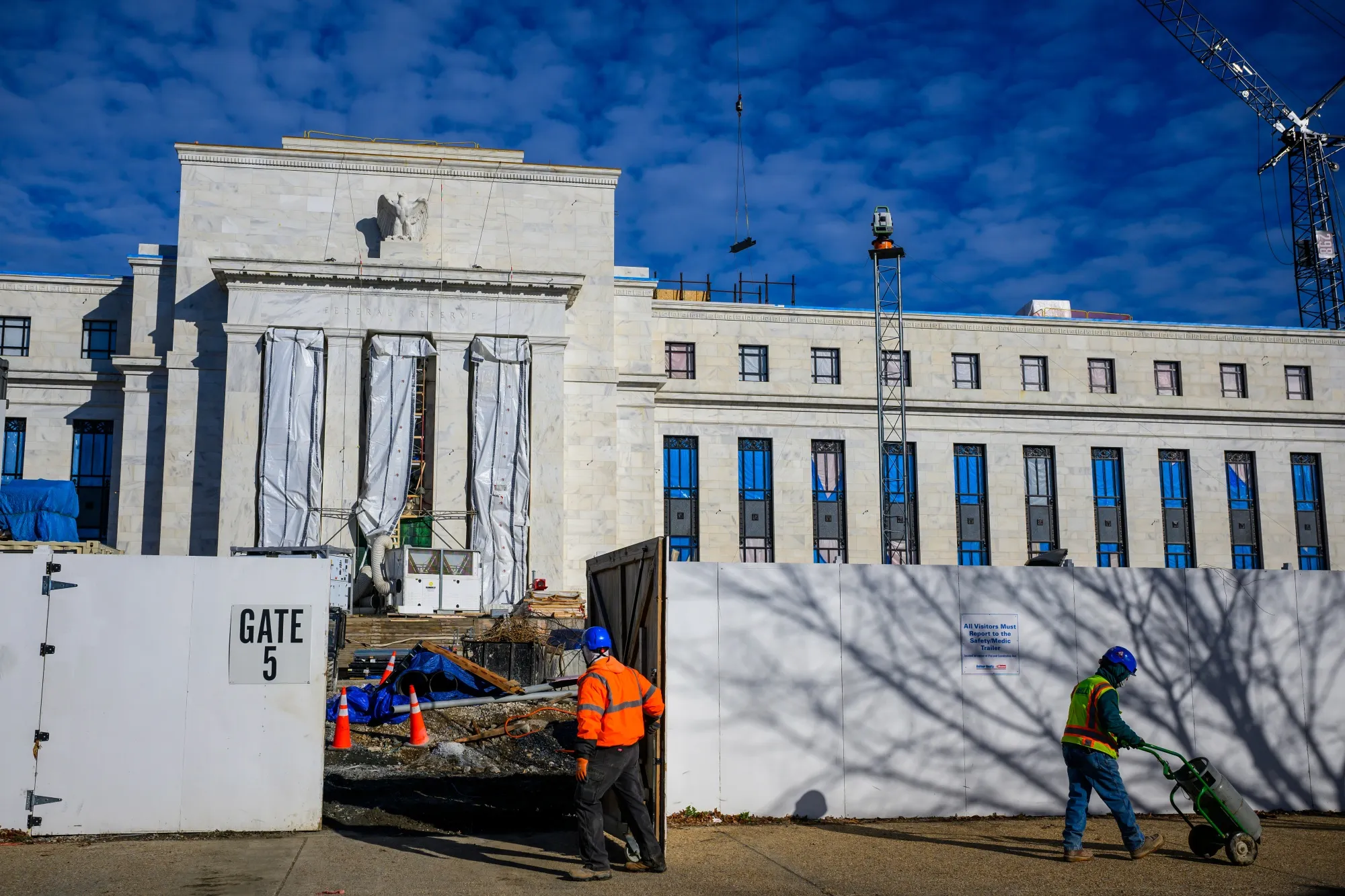 Construction workers outside the Marriner S. Eccles Federal Reserve building in Washington.
