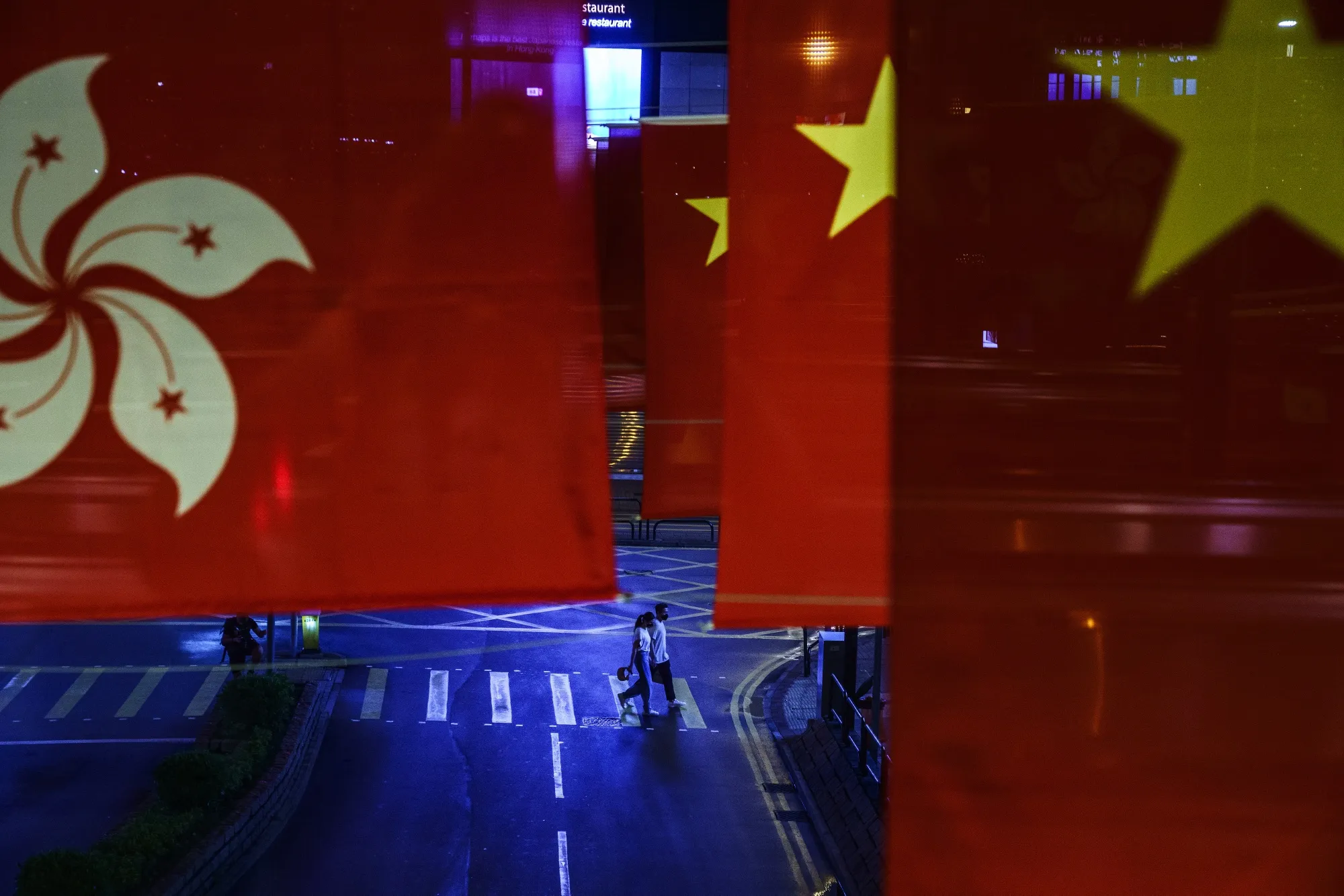 National flags of China and Hong Kong Special Administrative Region over a street&nbsp;in Hong Kong.